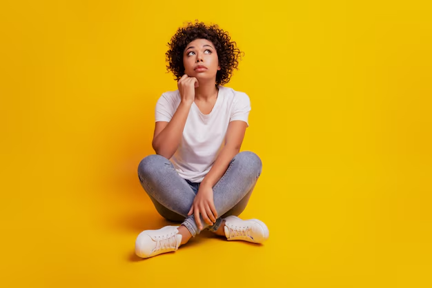 portrait young woman pondering something sit floor look up crossed legs 525549 502